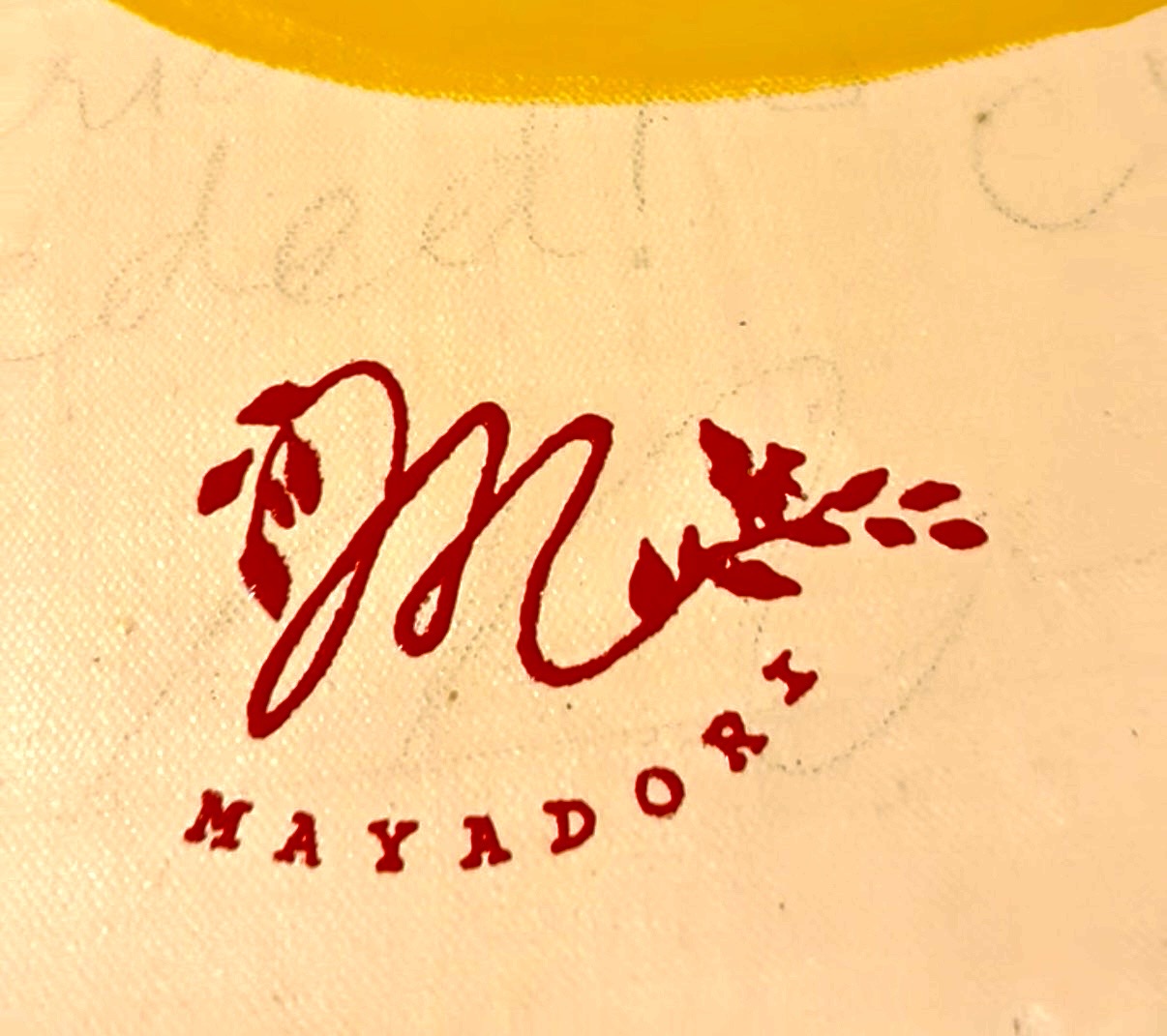 The Mayadori M mark printed in red ink
