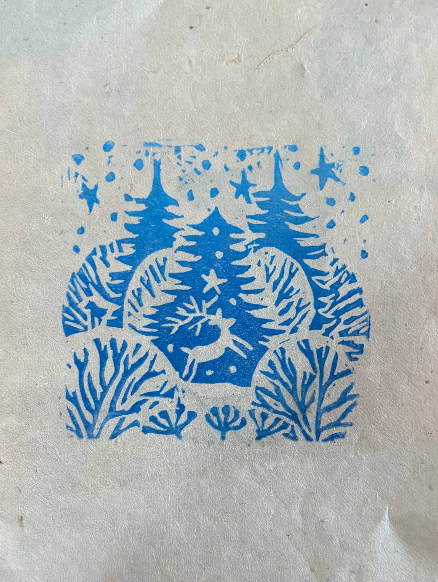 Winter Folk lino print in blue ink on handmade paper