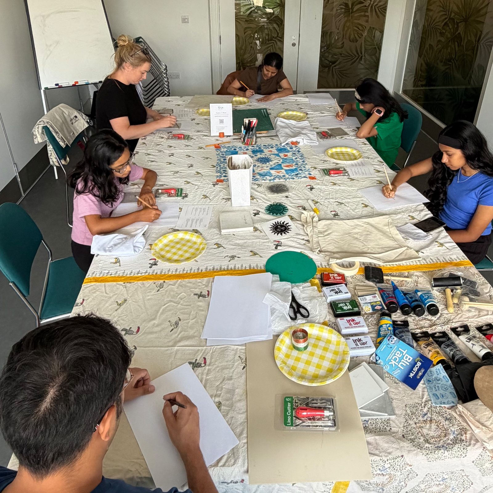 A team carving and printing lino at a Mayadori workshop
