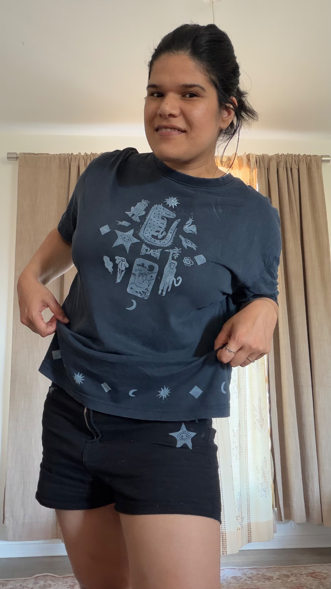 Person wearing a navy hand-printed celestial T-shirt