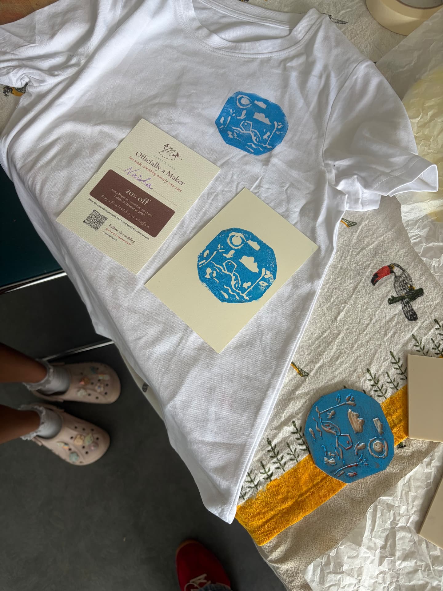 A hand-printed t-shirt and blue lino prints from a workshop