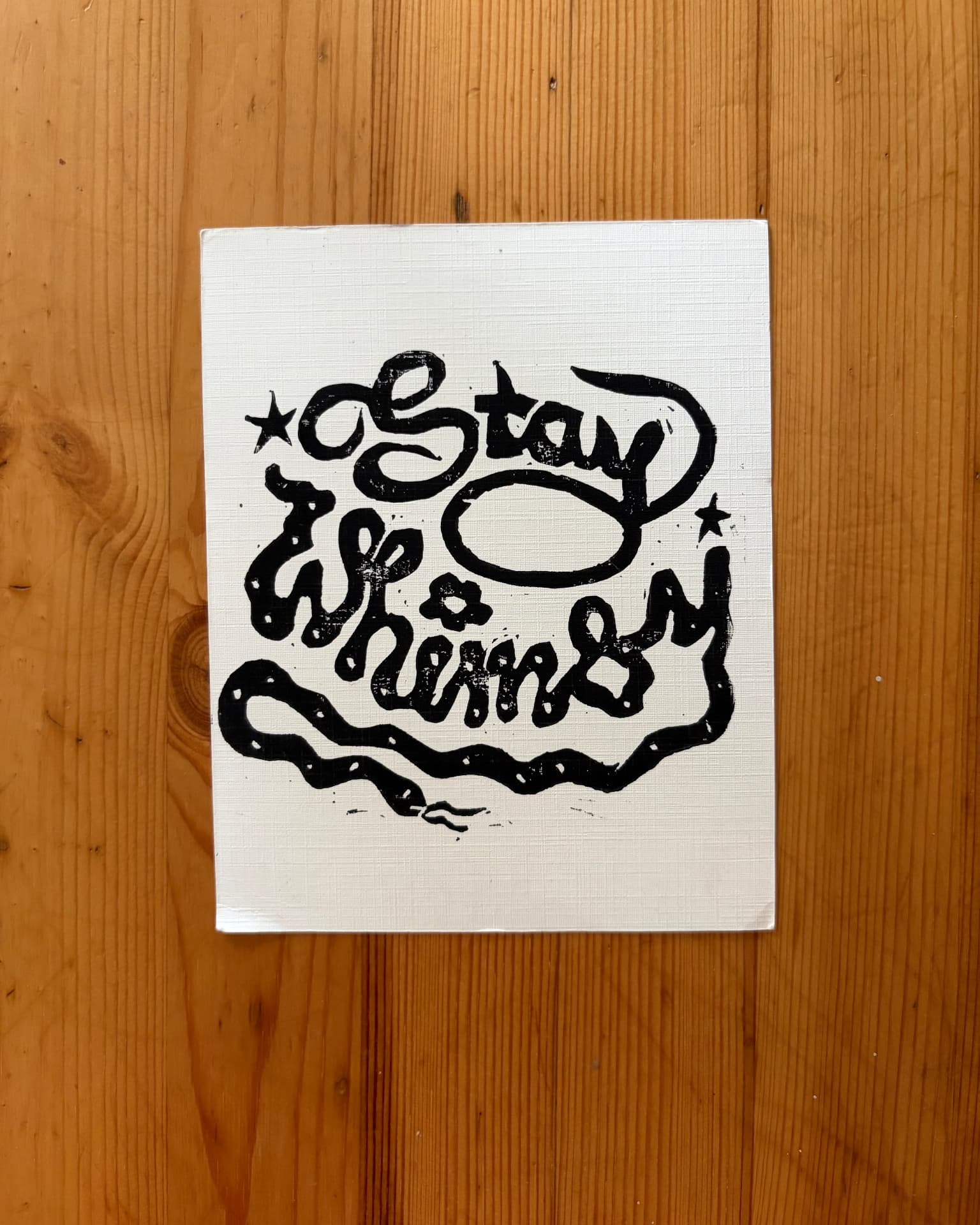 A hand-printed Stay Whimsy lino print