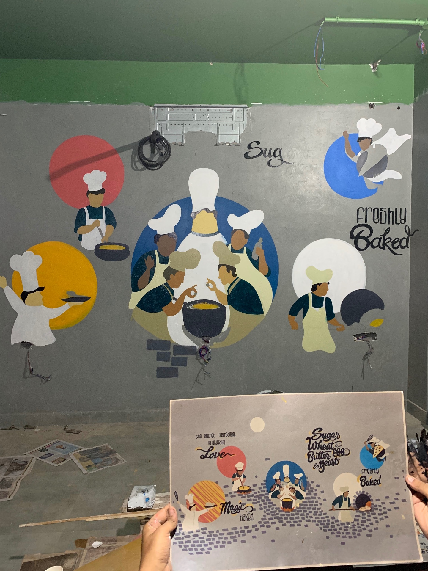 Mural in progress — chefs and lettering